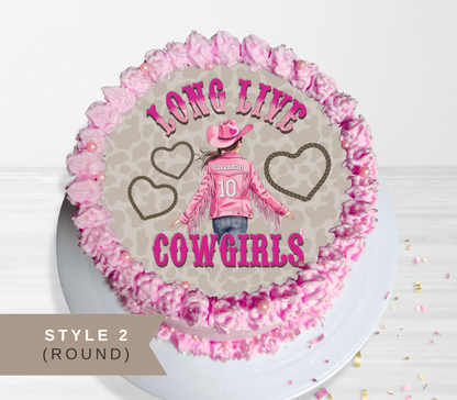 Round pink frosted cake topper or decoration featuring a cowboy girl illustration and the words 'LONG LIVE COWGIRLS' on a light gray background, shown on a white plate with a 'STYLE 2 (ROUND)' label overlay.
